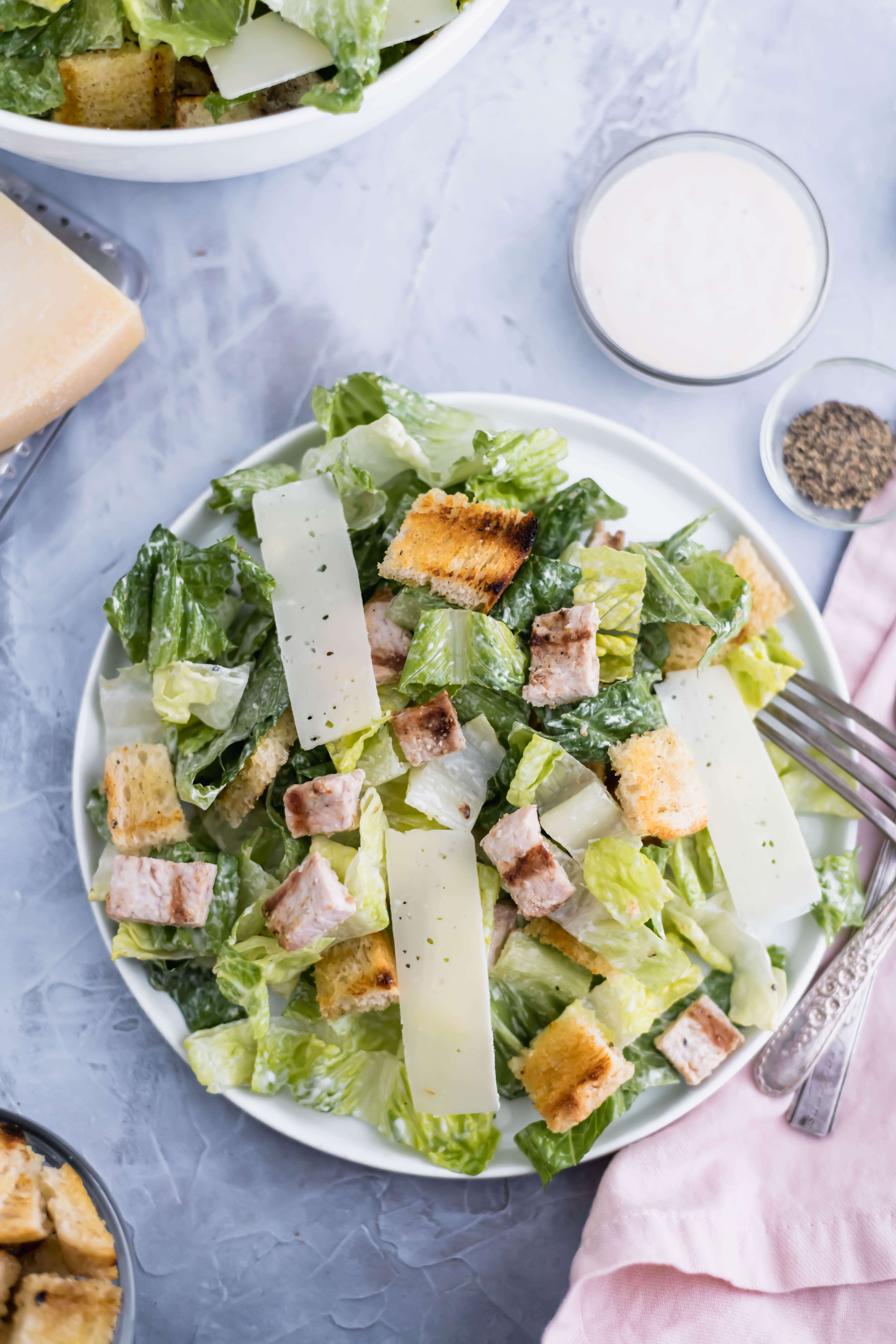 aerial shot of turkey caesar salad in a bowl